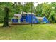 Backyard view of blue home showcasing an expansive wooden deck at 6238 Old 421 Rd, Liberty, NC 27298
