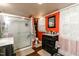 Cozy bathroom featuring a walk-in shower, a vanity with storage, and ample lighting at 6238 Old 421 Rd, Liberty, NC 27298
