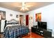 Bright bedroom with a ceiling fan, large windows, and cozy decor for comfortable living at 6238 Old 421 Rd, Liberty, NC 27298