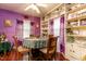 Charming dining room featuring purple walls, built-in shelving, and plenty of natural light at 6238 Old 421 Rd, Liberty, NC 27298