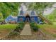 Charming blue two-story home featuring a well-maintained yard and inviting entrance at 6238 Old 421 Rd, Liberty, NC 27298