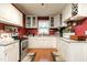 Bright, open kitchen featuring white cabinets, and modern appliances at 6238 Old 421 Rd, Liberty, NC 27298