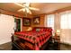 Comfortable main bedroom with a ceiling fan, natural light, and a decorative accent wall at 6238 Old 421 Rd, Liberty, NC 27298