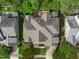 Stunning aerial view of a beautiful home featuring a landscaped backyard with a firepit and patio area at 629 Peach Orchard Pl, Cary, NC 27519