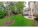 Expansive backyard with lush lawn, mature trees, and a patio area perfect for outdoor living at 629 Peach Orchard Pl, Cary, NC 27519