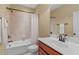 Functional bathroom with a combination tub and shower, vanity, and modern fixtures at 629 Peach Orchard Pl, Cary, NC 27519