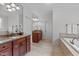 Bathroom featuring double vanities, tile flooring, and granite countertops at 629 Peach Orchard Pl, Cary, NC 27519