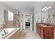 Bathroom featuring tile surround tub, walk in shower, and double vanity at 629 Peach Orchard Pl, Cary, NC 27519