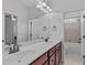 Bathroom featuring double sinks, a large mirror, and a combined shower and bath at 629 Peach Orchard Pl, Cary, NC 27519