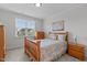 Cozy bedroom featuring a wood-frame bed, natural light, and a serene atmosphere at 629 Peach Orchard Pl, Cary, NC 27519