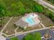 Aerial view of the community pool area featuring a main pool and kiddie pool surrounded by trees at 629 Peach Orchard Pl, Cary, NC 27519