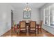 Formal dining room with a chandelier, hardwood floors, and elegant wainscoting at 629 Peach Orchard Pl, Cary, NC 27519