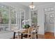 Bright dining room with a view of the deck through multiple windows at 629 Peach Orchard Pl, Cary, NC 27519