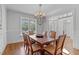 Dining room with hardwood floors, chandelier, and plenty of natural light at 629 Peach Orchard Pl, Cary, NC 27519