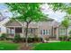 Exterior view of a home with a screened-in porch, deck, brick patio, and well-maintained lawn at 629 Peach Orchard Pl, Cary, NC 27519