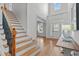 Bright foyer with high ceilings, staircase, wood floors, and plenty of natural light at 629 Peach Orchard Pl, Cary, NC 27519