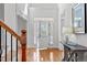 Inviting foyer with hardwood floors, a beautiful staircase, and a charming front door with sidelights at 629 Peach Orchard Pl, Cary, NC 27519