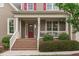 Inviting front entrance with a brick staircase, front porch, and lush greenery enhancing curb appeal at 629 Peach Orchard Pl, Cary, NC 27519