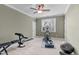 Gym with carpet flooring, a ceiling fan, and weights at 629 Peach Orchard Pl, Cary, NC 27519