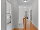 Hallway with wood floors and access to the bedroom at 629 Peach Orchard Pl, Cary, NC 27519