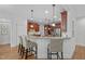 The kitchen has stainless appliances, granite counters, an island and bar seating at 629 Peach Orchard Pl, Cary, NC 27519