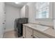 Well-equipped laundry room with a modern washer/dryer set and sink at 629 Peach Orchard Pl, Cary, NC 27519