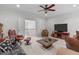 Spacious living room with plush seating, ceiling fan, and a view of the upper level at 629 Peach Orchard Pl, Cary, NC 27519