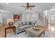 Living room with staircase and hardwood floors open to the kitchen in the background at 629 Peach Orchard Pl, Cary, NC 27519