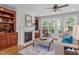 Cozy living room featuring a fireplace, built-in bookshelves, and ample natural light at 629 Peach Orchard Pl, Cary, NC 27519