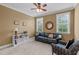 Comfortable living room with a black leather sofa and plenty of natural light from windows at 629 Peach Orchard Pl, Cary, NC 27519