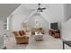 Relaxing living room with comfortable couches, TV, and natural light from the windows at 629 Peach Orchard Pl, Cary, NC 27519