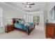 Spacious main bedroom with carpet, tray ceiling, ceiling fan, and natural light at 629 Peach Orchard Pl, Cary, NC 27519