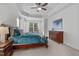 Bright main bedroom featuring carpet, trey ceiling, and a large window at 629 Peach Orchard Pl, Cary, NC 27519