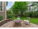 Charming brick patio with seating area, perfect for enjoying the serene backyard garden at 629 Peach Orchard Pl, Cary, NC 27519