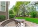 Charming brick patio with seating area, perfect for enjoying the serene backyard garden at 629 Peach Orchard Pl, Cary, NC 27519