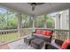Screened porch with wicker furniture, ceiling fan and tree-lined backyard view, perfect for outdoor relaxation at 629 Peach Orchard Pl, Cary, NC 27519