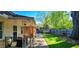 Spacious backyard featuring a covered porch, stone-paved path, green lawn, and wood fence at 704 W Front St, Burlington, NC 27215