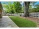 Wide view of the backyard showing a healthy lawn and brick patio at 704 W Front St, Burlington, NC 27215