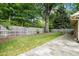 Spacious backyard with lush green grass, mature shade trees, and a stone tile patio area at 704 W Front St, Burlington, NC 27215