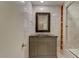 This bathroom boasts a vanity, framed mirror, a shower/tub with ceramic tile, and built in shelving at 704 W Front St, Burlington, NC 27215