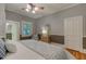 A bedroom with hardwood floors, large window, and a mirror at 704 W Front St, Burlington, NC 27215