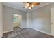 Comfortable bedroom featuring soft gray walls, carpet, a ceiling fan, and a closet at 704 W Front St, Burlington, NC 27215
