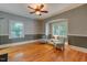 Versatile bonus room featuring hardwood floors, chair railing, and two bright windows at 704 W Front St, Burlington, NC 27215