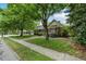 Beautiful one-story brick home with mature trees, green lawn and established landscaping at 704 W Front St, Burlington, NC 27215