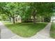 Well-maintained yard with mature trees offering ample shade and curb appeal at 704 W Front St, Burlington, NC 27215
