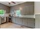 A kitchen is shown with gray cabinets and stainless steel appliances at 704 W Front St, Burlington, NC 27215