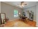 A home office is shown with hardwood floors, a large desk, and natural light at 704 W Front St, Burlington, NC 27215