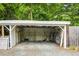 View of an empty shed with white walls, gravel floor and surrounded by a wooden fence at 704 W Front St, Burlington, NC 27215