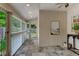 Bright sunroom featuring neutral walls, slate tile flooring, ample windows, and a view to the backyard at 704 W Front St, Burlington, NC 27215
