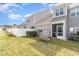 Townhome backyard with a swing, lawn, white fence, and screened-in patio, perfect for outdoor relaxation and entertainment at 7328 Caversham Way, Raleigh, NC 27617